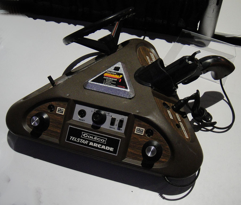 a photo of a coleco telstar arcade showing the top side with a silver triangular cartridge in the top.